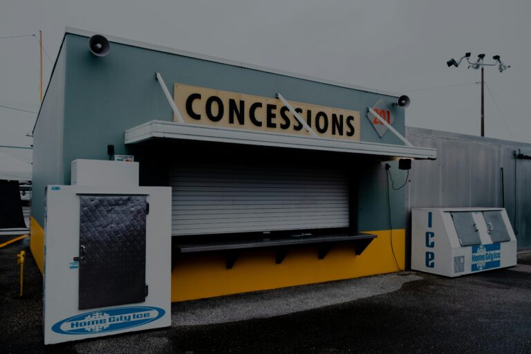 Empty concessions stand with closed shutters and ice machines outside.