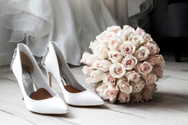 Elegant bridal shoes and bouquet of roses perfect for wedding inspirations.